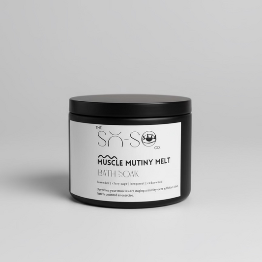 Bath soak container labeled 'Muscle Mutiny Melt' on a wooden surface.